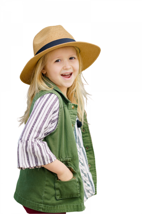 girl in a hat stands and smiles